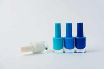 colored nail polishes on a white background