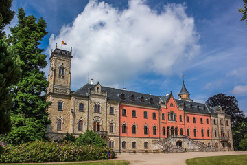 Sychrov Castle with typical pink facade. Neo-Gothic style chateau with beautiful english style park in summer. Bohemian Paradise, Czech Republic