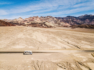 Aerial view of a motorhome driving on a highway in the desert of USA California