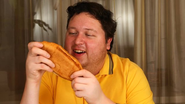 Stylish Man Eating A Croissant At Home