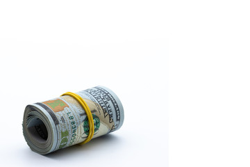 100 dollars rolled into a roll isolated on white background. concept wealth, criminal money,...