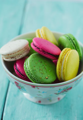 macaroons in a bowl on wooden surface