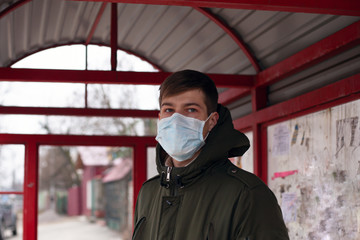 caucasian man and medical face mask on public bus station , covid-19 virus, quarantine,epidemic,...