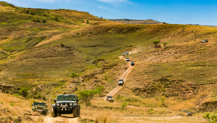 Harrismith, South Africa - October 03, 2015: Jeep 4x4 Vehicles on a Dirt Road in the Drakensberg - obrazy, fototapety, plakaty