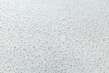 raindrops on glass natural color background.