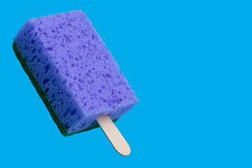 Sponge popsicle on a stick isolated on blue background
