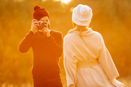 Man Taking A Photo Of His Friend Outdoors