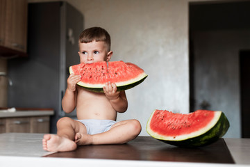 Front view young boy eating watermelon