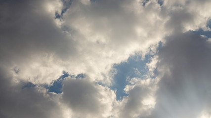 Beautiful white fluffy rainclouds on vivid blue sky in a sunny day