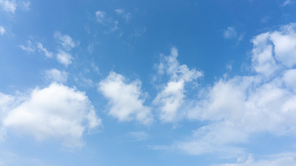 Naklejka na ściany i meble Beautiful white fluffy clouds on vivid blue sky in a sunny day