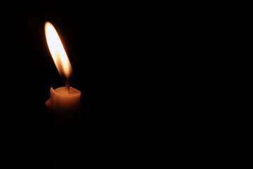 close details of candle in the dark with space for text