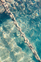 A rusty boat chain underwater