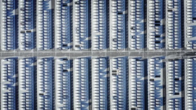 Top aerial view parking with snow covered cars. fully occupied Parking. zoom out shot