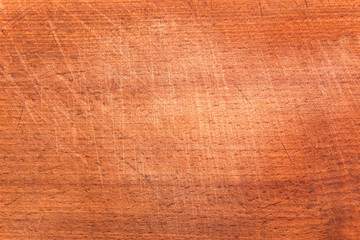 Brown scratched wooden cutting board. Wood texture