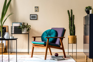 Interior design of retro modern living room with stylish blue navy commode, cacti in lastrico pot, design armchair with pillow, organizer and elegant personal accessories. Stylish home decor. Template