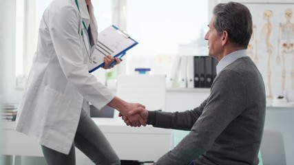 Handheld view of senior man and doctor in doctor’s office. Shot with RED helium camera in 8K 