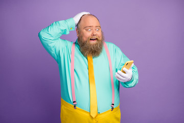 Surprised shocked man big abdomen use cellphone read social network news scream wow omg wear yellow...