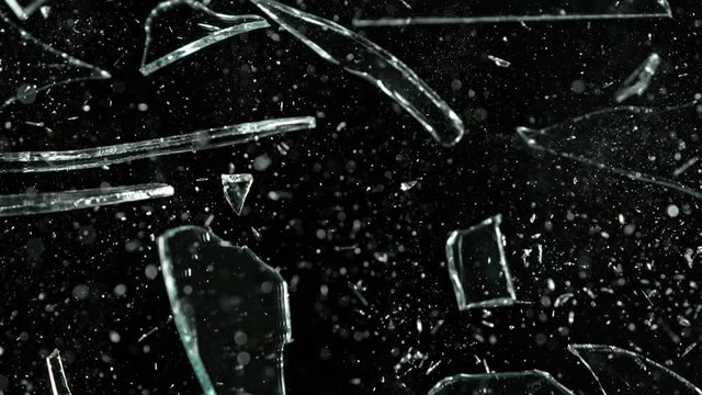 Super Slow Motion Shot of Real Glass Break at 1000 fps Isolated on Black Background.