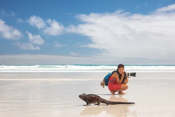 Foto op Canvas Travel adventure tourist nature photographer on vacation on Galapagos beach with Iguana walking by on Tortuga bay beach, Santa Cruz Island, Galapagos Islands. Funny holidays image, Ecuador. © Maridav