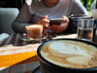 Close-up Cappuccino Coffee on wood table in morning.