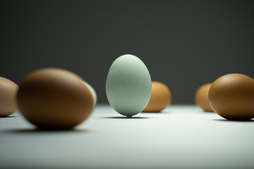 Many eggs are in a white table in the dark.