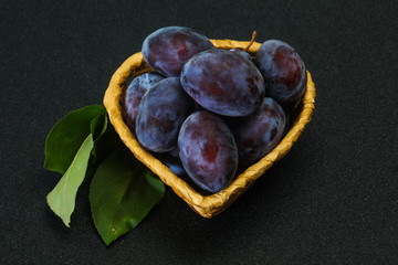 Ripe plum heap in the basket
