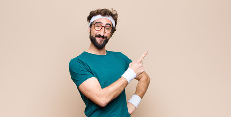 young sports man expressing a concept against flat wall