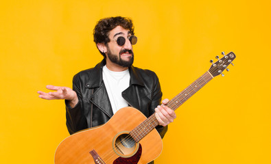 young musician man feeling clueless and confused, not sure which choice or option to pick, wondering with a guitar, rock and roll concept