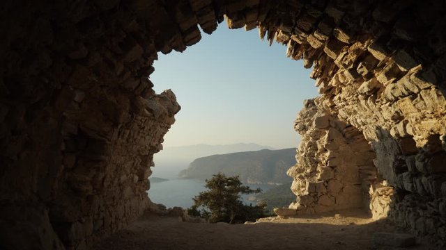 View on the greek coast through the window of medieval Castle of Monolithos ruins, Rhodes Island, Greece