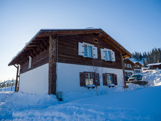 Alpine-style hotel in the ski resort Gornaya Salanga. Chalet in the snow. Winter day