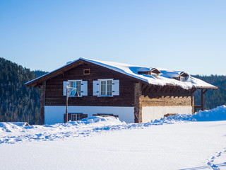 Alpine-style hotel in the ski resort Gornaya Salanga. Chalet in the snow. Winter day