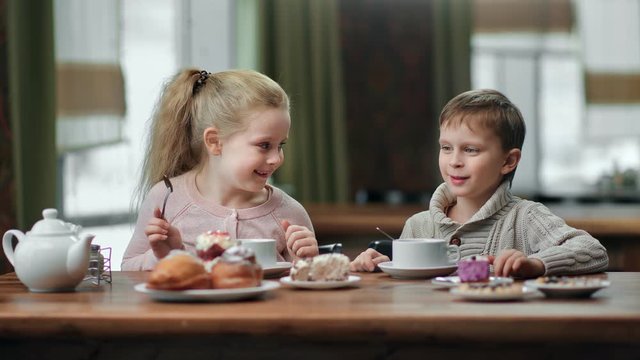Two female and male child enjoying delicious lunch at restaurant together. Medium shot on RED camera