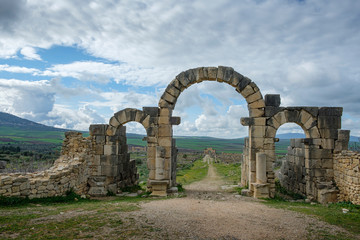 Roman entrance gate in the archaeological site of Volubilis near Meknes / Morocco