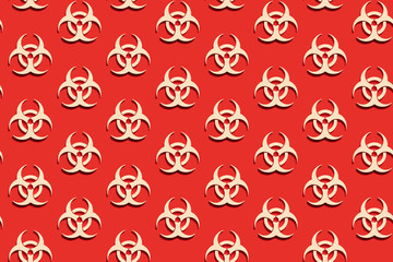 Obraz premium Seamless Pattern of Symbol of biohazard warning on red backdrop. Epidemic coronavirus virus. Biohazard, radioactive, toxic waste.