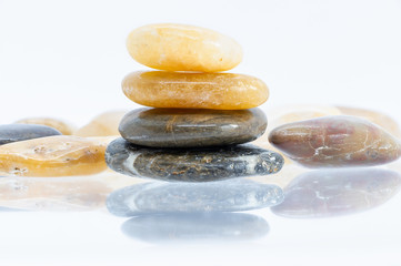Pile of round stones from sea isolated on white background
