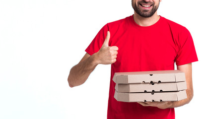Delivery pizza boy holding boxes and thumbs up medium shot