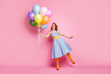 Full size photo of positive cheerful lady feel carefree enjoy fifty style rest relax hold many baloons laugh wear tights blue good look clothes isolated over pink color background