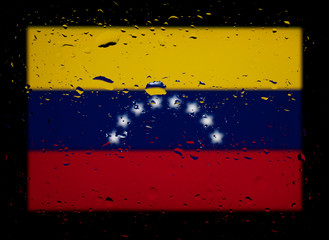 The national flag of Venezuela. Abstract photo with water drops on a black background.