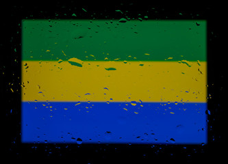 The national flag of Gabon. Abstract photo with water drops on a black background.