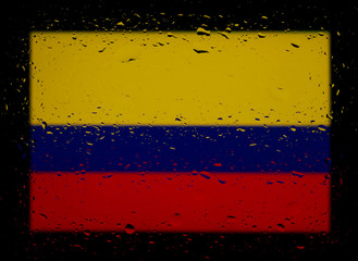 National flag of Colombia. Abstract photo with drops of water on a black background.