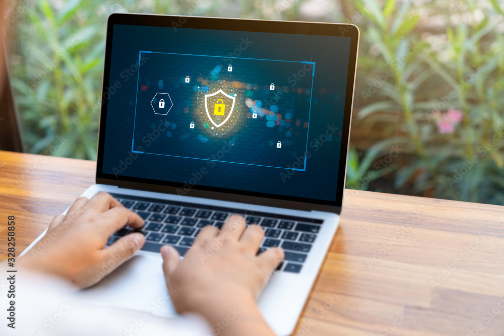 Poster person using a laptop computer with data protection, cyber security, information safety and encrypti