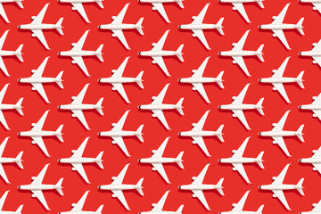 Modern red background with white airplanes. Business travel.