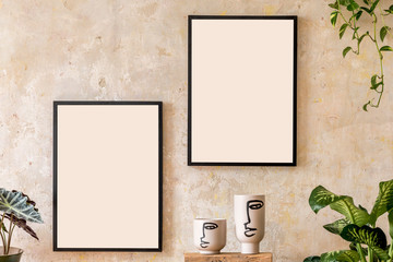 Interior design of living room with two black mock up poster frames, shelf, vases, plants and...