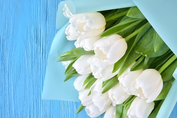 Bouquet of elegant white tulips on blue wooden background. Beautiful bunch of tender spring...