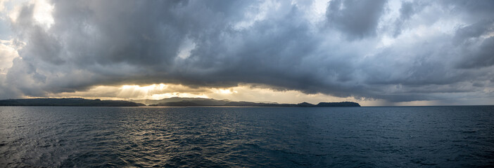 Stormy cloud with rain cloud and ray of light emerge through the large cloud at Koh Kood or Koh Kut, Trad province, Thailand.