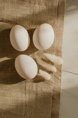 Organic white eggs of chicken on brown sack for background texture in natural light. Easter concept. Concept of organic natural farming.