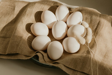 Organic white eggs of chicken on brown sack for background texture in natural light. Easter concept. Concept of organic natural farming.
