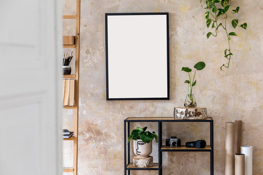 Interior design of living room with black poster mock up frame, shelf, cacti, plant, books, photo camera, wooden ladder and elegant personal accessoreis. Grunge wall. Stylish home decor. Template. 