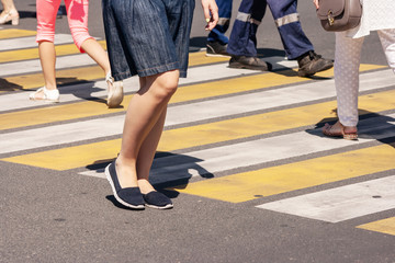 people crossing the street at pedestrian crossing