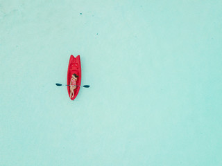 Aerial view of woman kayaking in Bacalar Mexico shot with drone